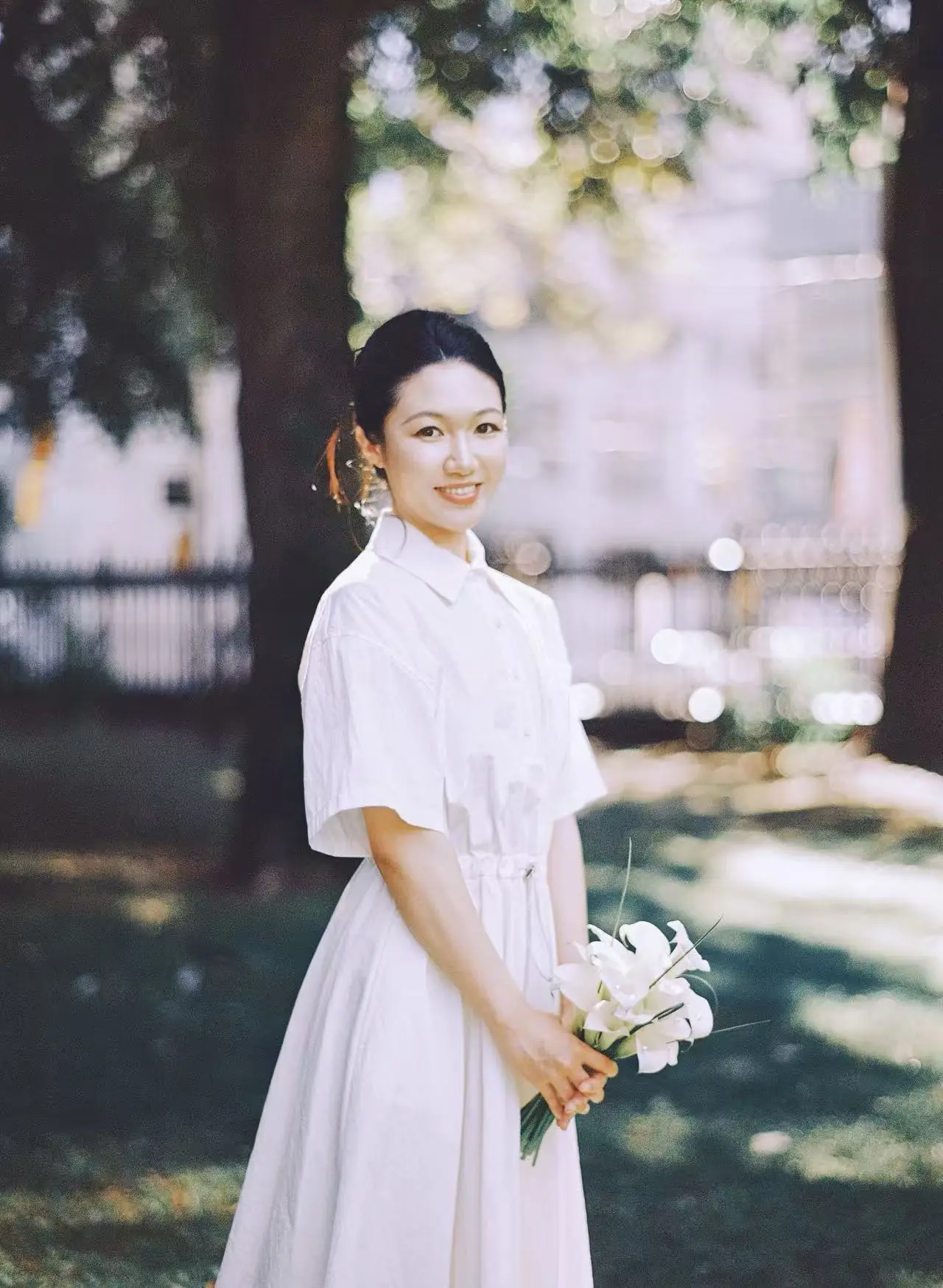 Bride holding white flowers outdoors