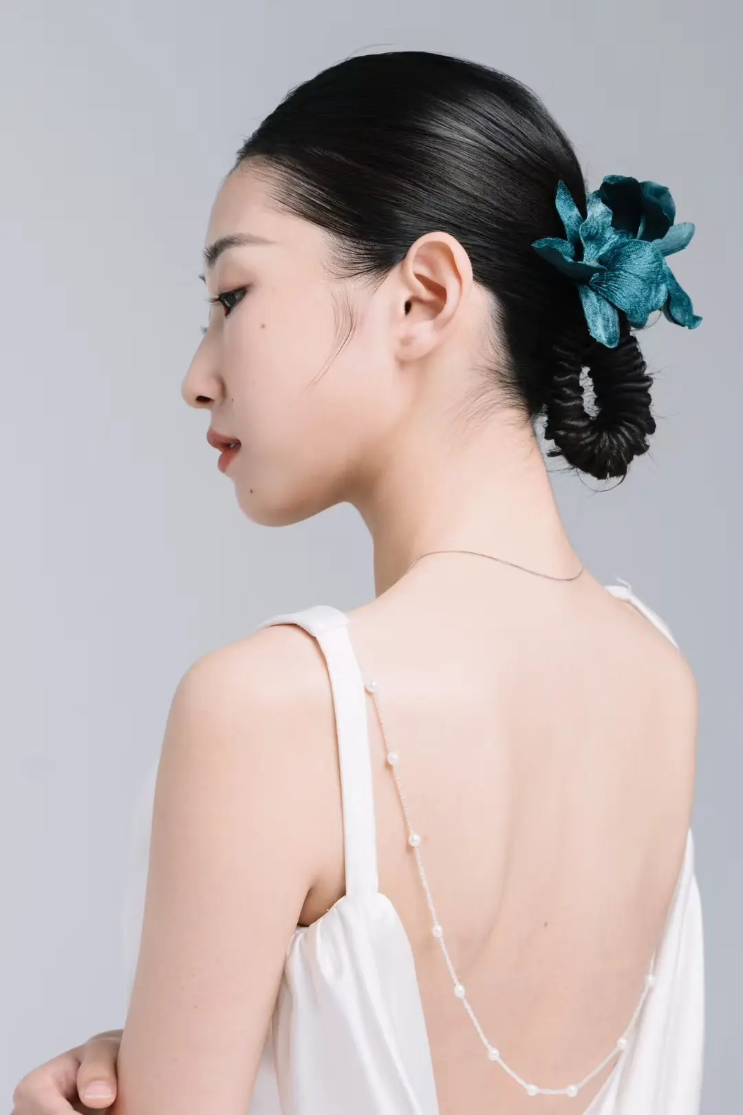 Bridal hair detail with a teal floral accent
