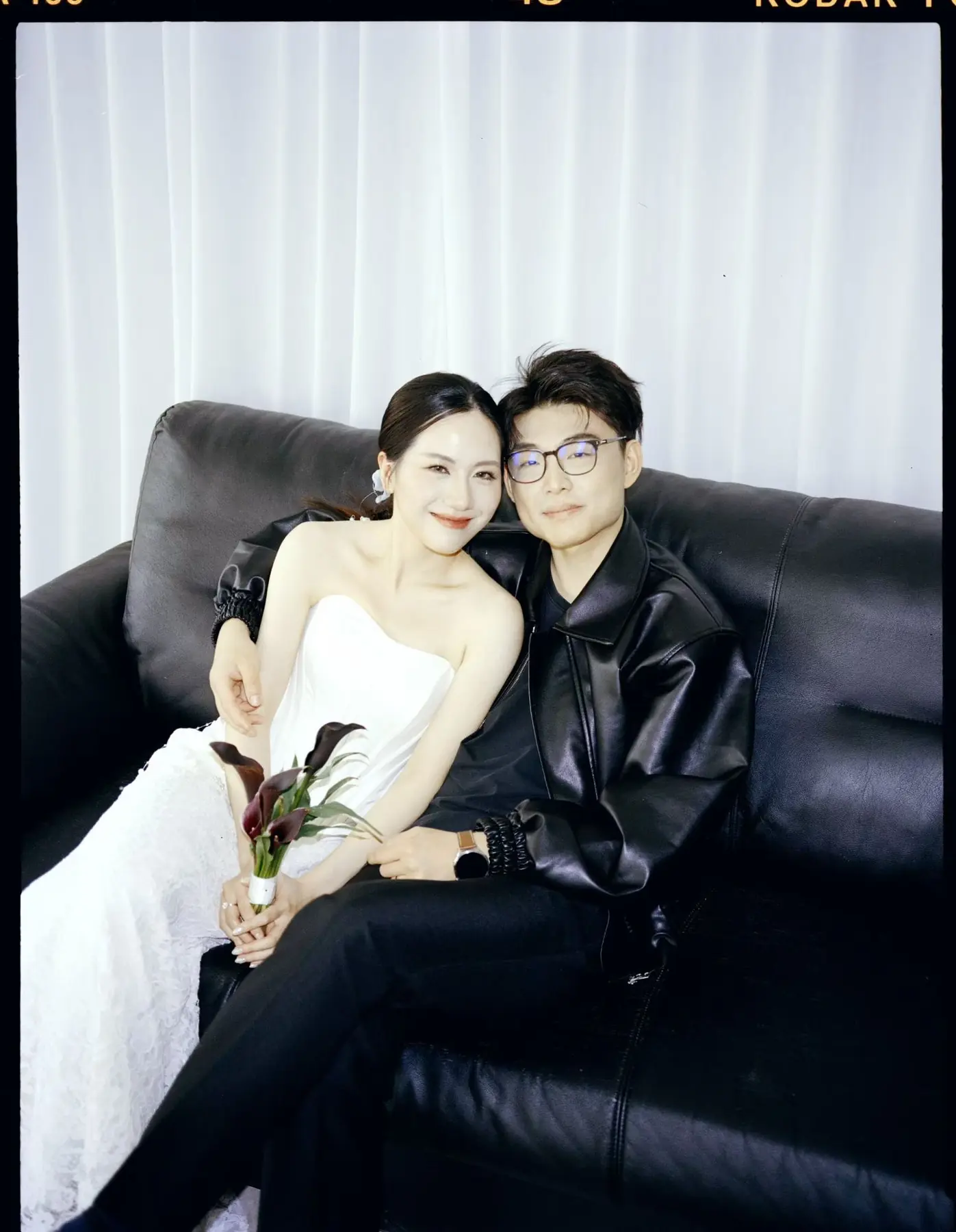 Relaxed seated portrait of newlyweds