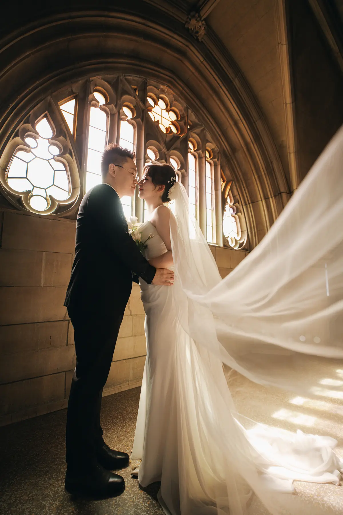 Bride and groom in warm architectural light
