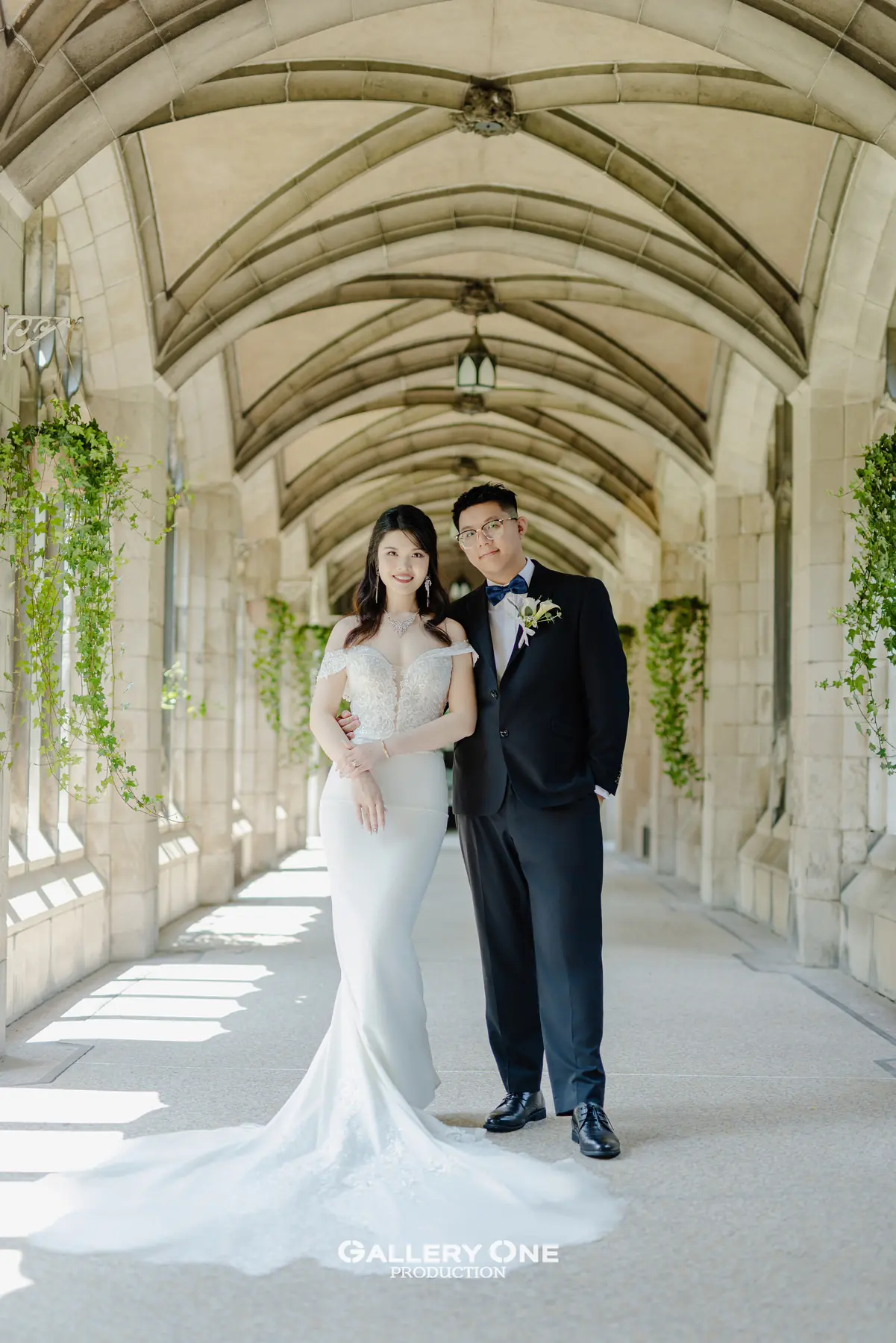 Bride and groom in a bright stone corridor