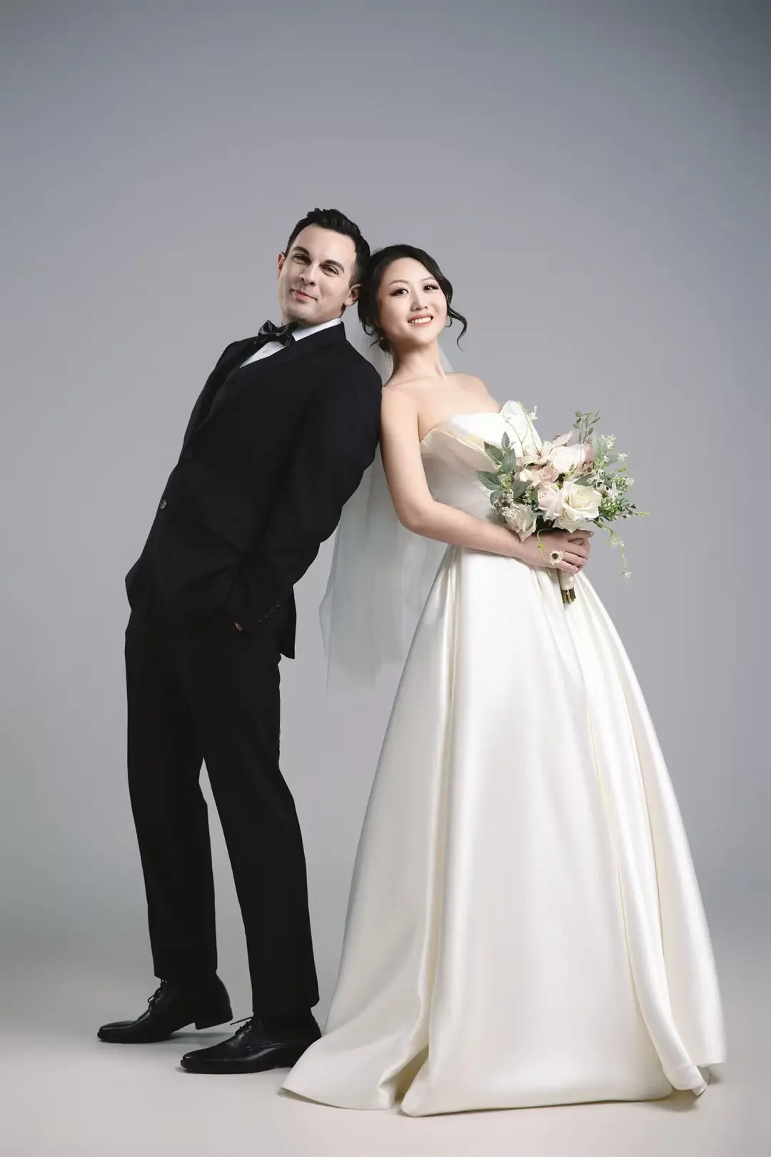 Studio wedding portrait with a full bridal gown
