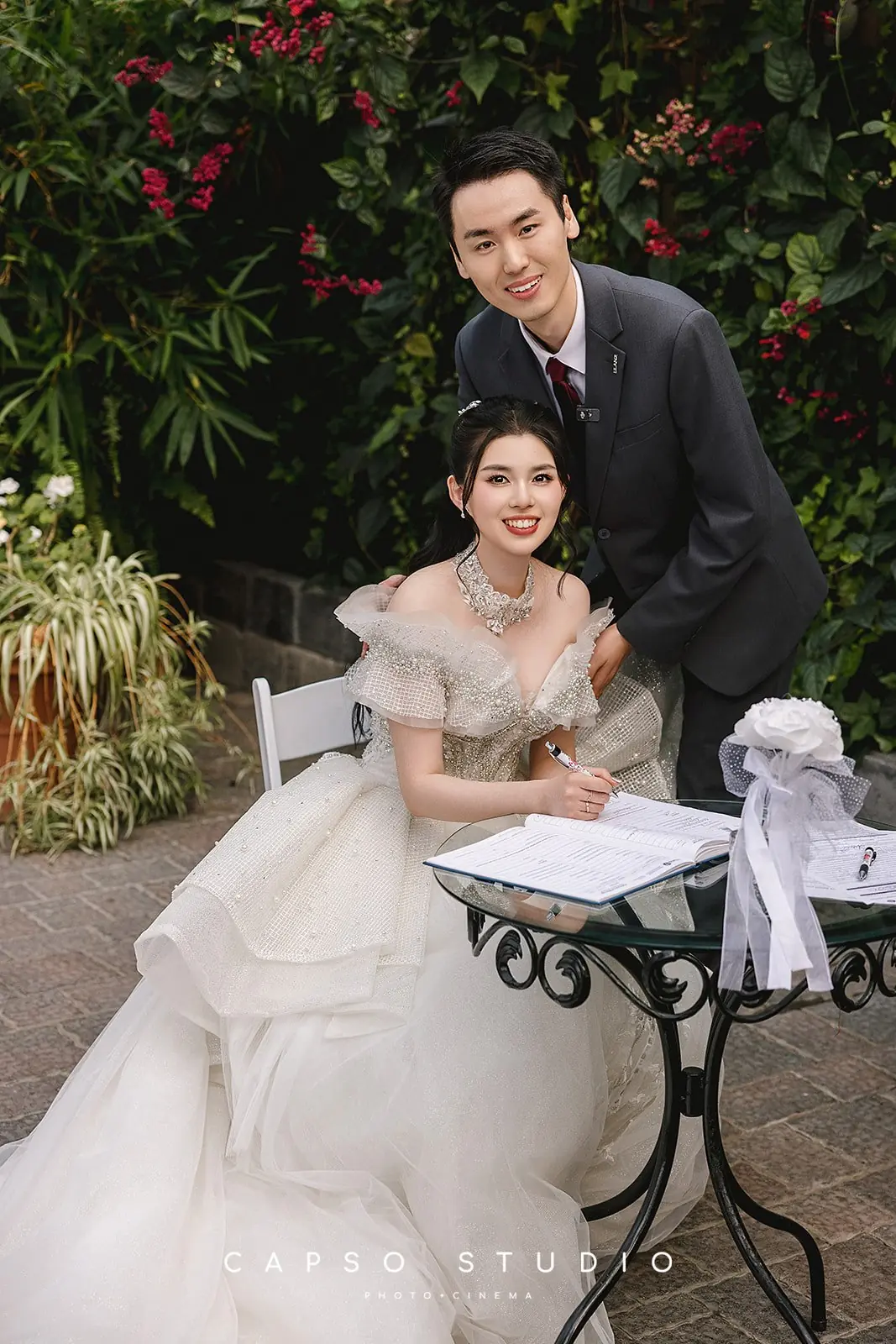 Newlyweds signing at an outdoor ceremony