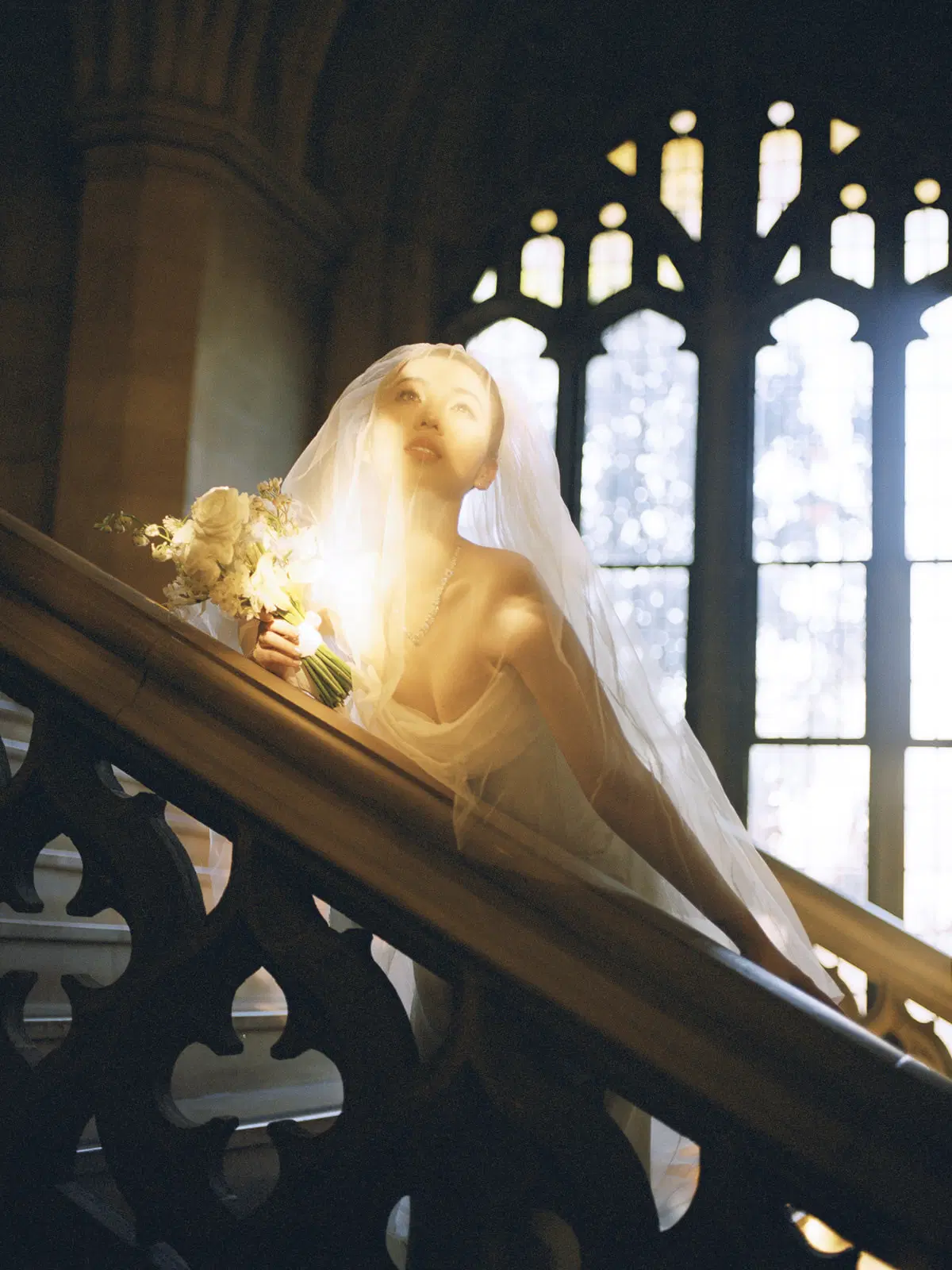 Sunlit bridal portrait in a historic stairway