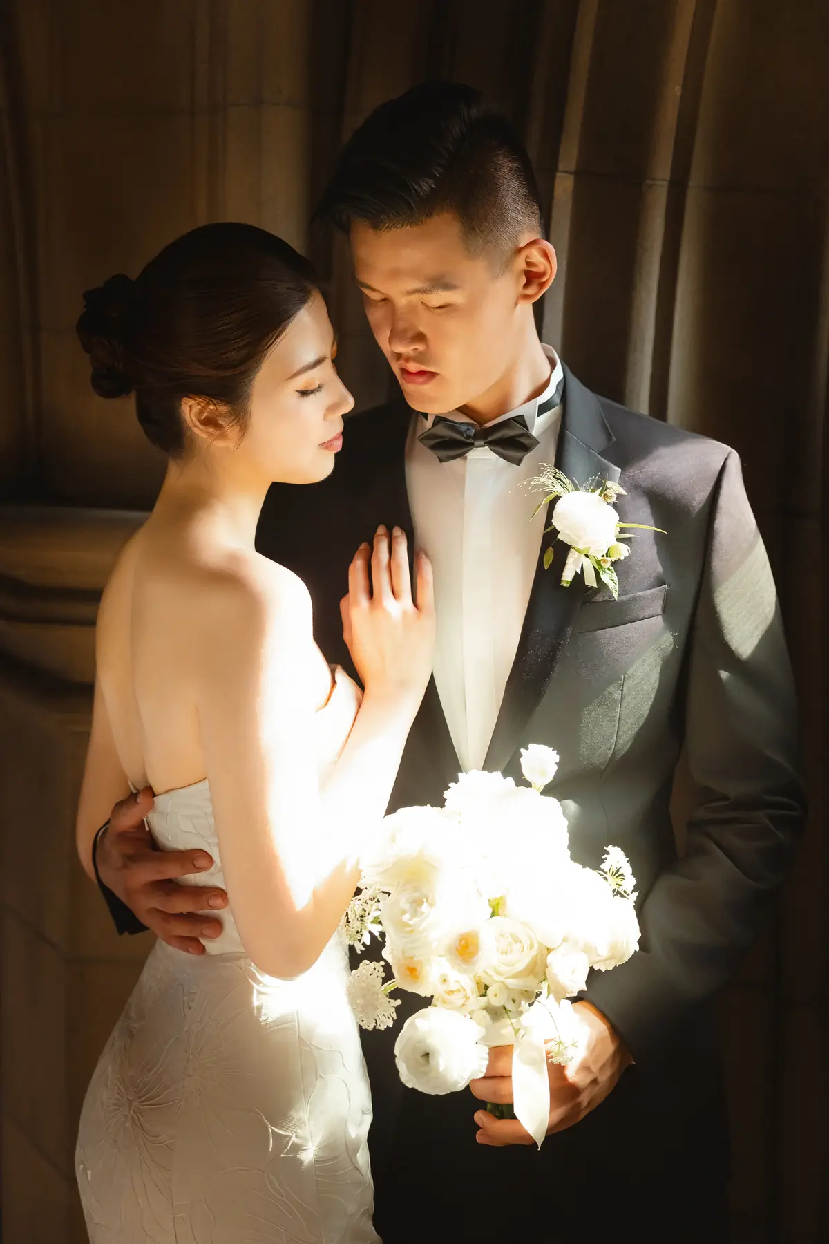 Bride and groom in warm architectural light