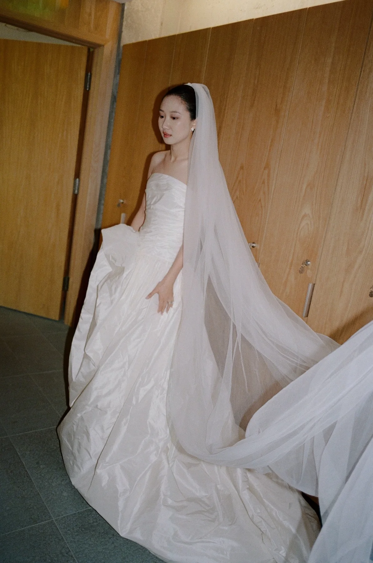Bride in a sculptural gown and long veil