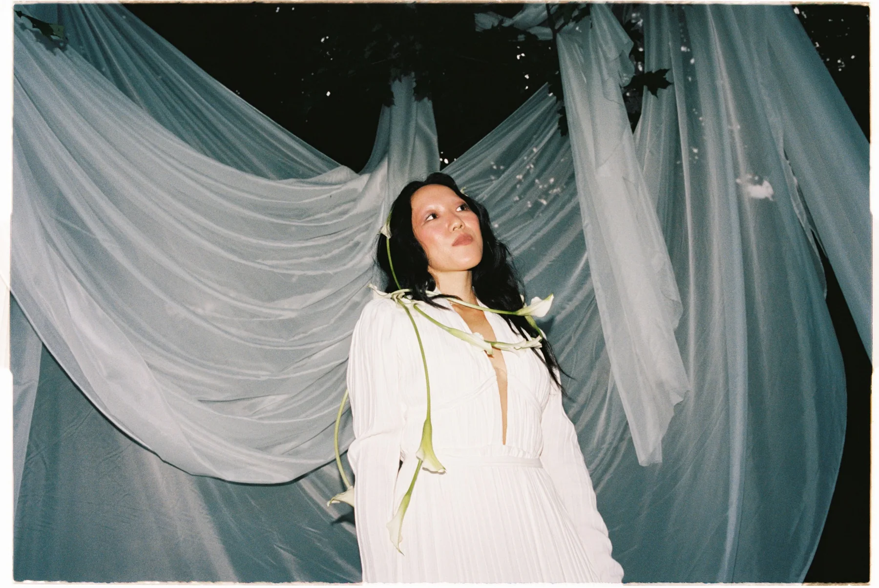 Bride framed by sweeping fabric