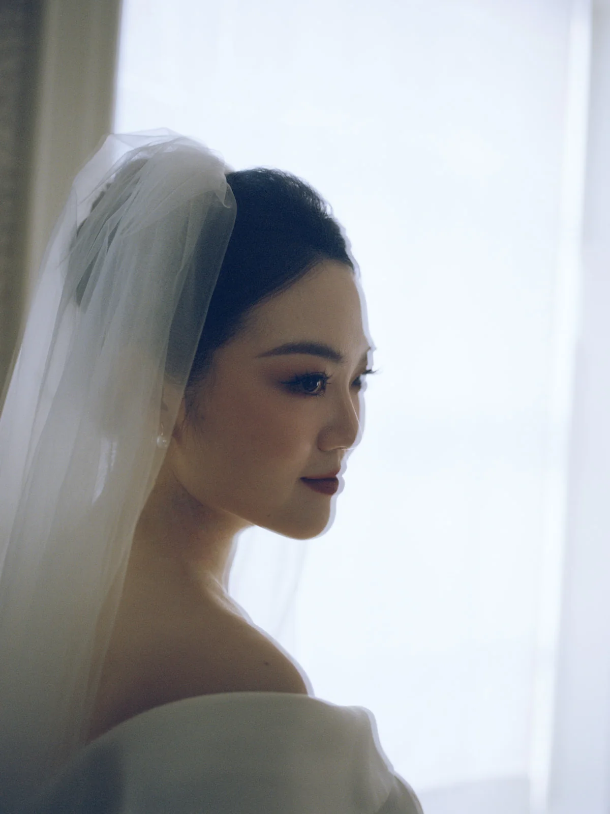 Soft bridal profile beside a window