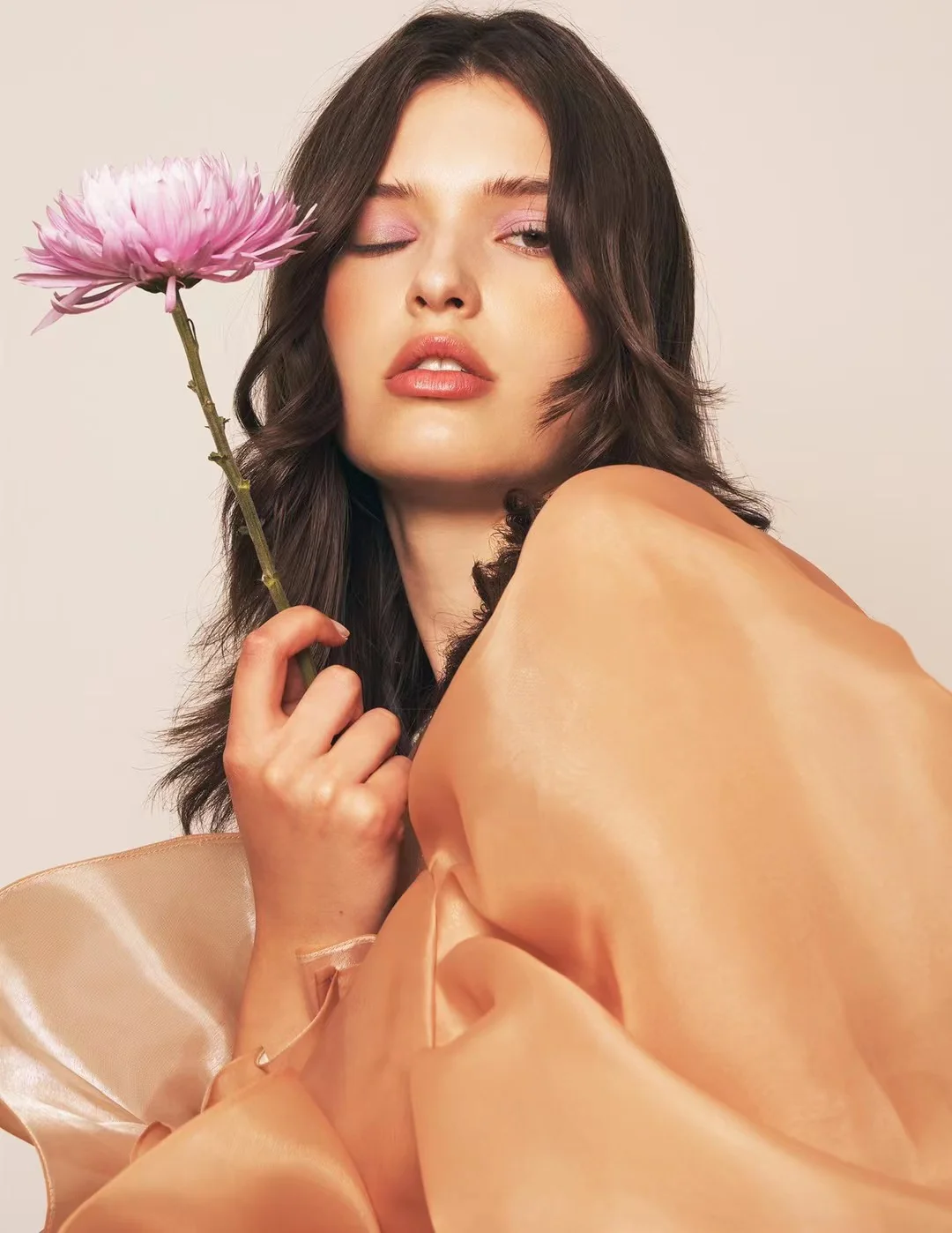 Soft editorial beauty portrait with a flower