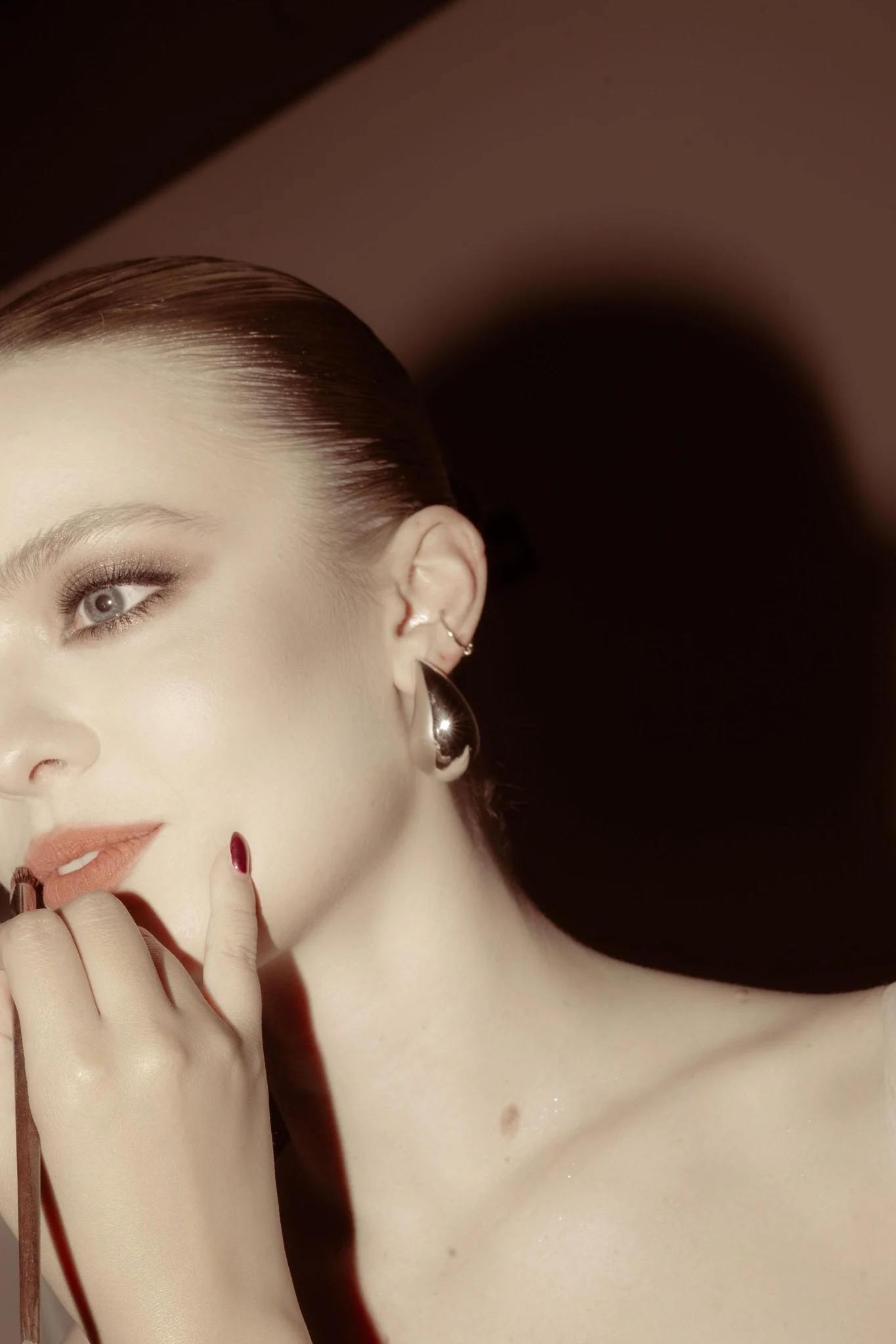 Editorial makeup close-up with deep auburn tones
